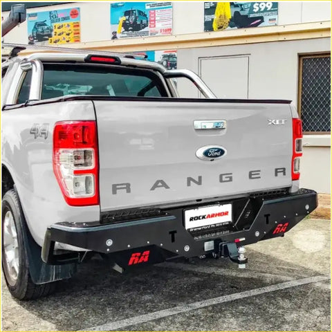 Silver ford ranger ute with black rockarmor steel rear step towbar and red branding for offroad 4wd use