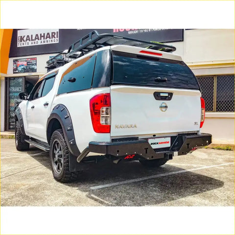 White nissan navara ute with black rugged steel rockamor elite rear step towbar for offroad 4wd use back view