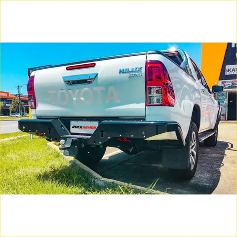 Black rockarmor elite steel rear step bumper with towbar on white toyota hilux sr5 rear side for 4wd ute offroad use