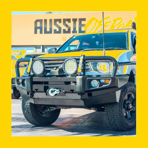 Black metal rockarmor brushbar with two circular led lights mounted on front bumper for mitsubishi triton mn ml