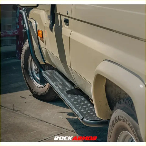 Black diamond plate steel side step with curved ends mounted on beige toyota troopy carrier 4wd ute offroad