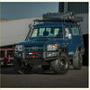 Deep blue toyota land cruiser with black rockarmor brushbar front bumper and roof rack for offroad 4wd use