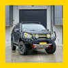 Black isuzu d-max with rockarmor gt hoop steel bullbar full bar replacement rugged bumper roof rack off-road tires