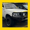 White toyota land cruiser with black steel rockarmor gt hoop bullbar and off-road tires for 105 series 98-07