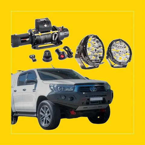 Black and silver steel winch with coiled cable remote controls and led light bars above white toyota hilux n80 bullbar
