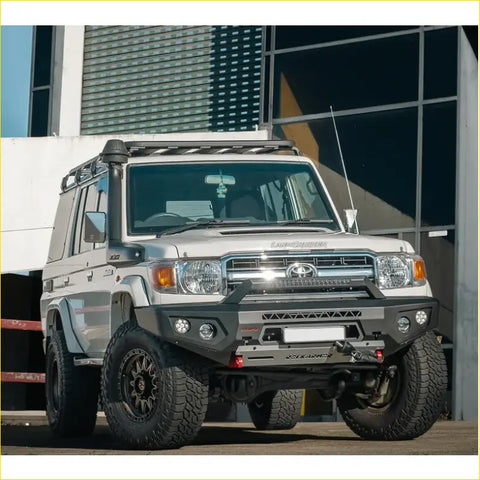 Silver toyota land cruiser 70 with black offroad tires featuring rockarmor gt hoopless steel bullbar for 4wd use