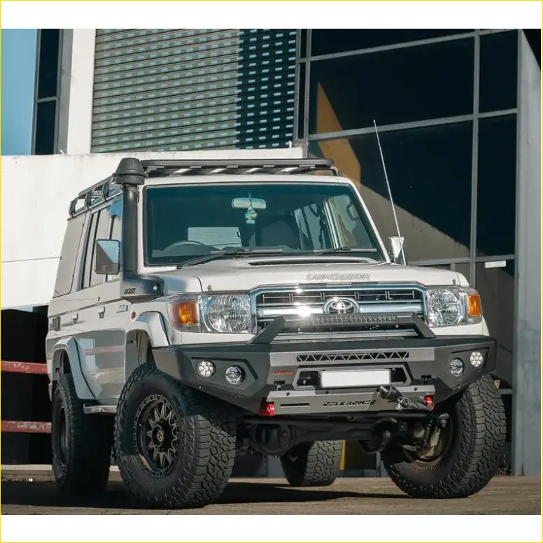 Silver toyota land cruiser 70 with black offroad tires featuring rockarmor gt hoopless steel bullbar for 4wd use