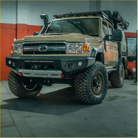 Tan toyota land cruiser with black steel rockarmor gt hoopless bullbar and rugged offroad tires for 4wd ute use