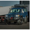 Deep blue toyota land cruiser with black rockarmor premium bullbar front bumper and roof rack tent for 4wd offroad use