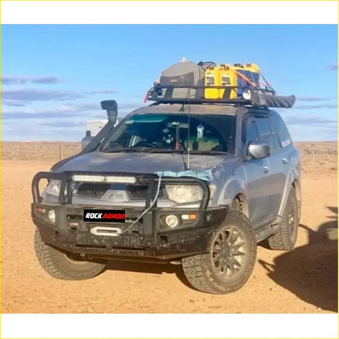 Dark gray 4wd ute with black steel rockarmor premium bullbar and roof rack carrying yellow gear for offroad use