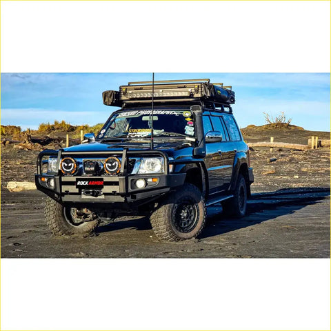 Black nissan patrol with rugged offroad tires and rockarmor premium steel bullbar for 4wd use