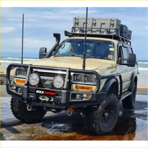 Beige offroad 4wd suv with black rockarmor premium steel bullbar and roof rack for toyota landcruiser fj80 ute
