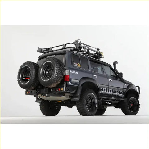 Black rugged 4wd suv with rockarmor steel dual wheel carrier and offroad tires for toyota landcruiser fj80 back side