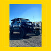 Black nissan navara np300 d23 with rockarmor steel rockslider side steps rugged off-road build and roof rack