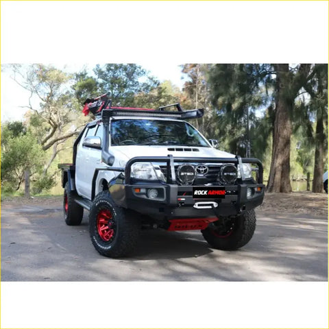 Black and red steel rock armor front bumper with winch mount and headlights on white toyota hilux ute for offroad 4wd