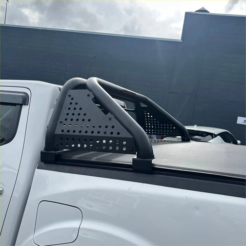 Backside view of black perforated metal roll bar t10 with curved tubular bars and mounts for isuzu d-max 2005-2011