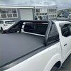 Black perforated steel roll bar sport bar with integrated side rails mounted on the back of a white isuzu d-max truck