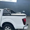 White isuzu d-max 2024 pickup truck backside with black perforated metal roll bar and matching tonneau cover