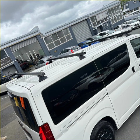 Black heavy duty roof rack 3 piece set mounted on white toyota hiace zr zx 2019 van back side view