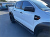 White ford ranger pickup with black stainless steel 4 inch oval tube running board and rugged tires side view