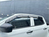Black plastic window visors installed on a white isuzu d-max 2021-2023 for weather protection