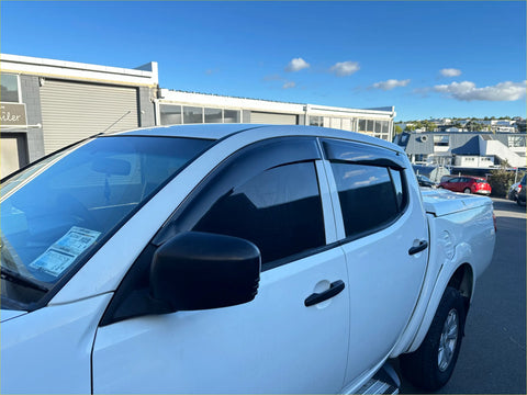 White pickup truck with black side mirrors and window trim featuring s window monsoons weather shields for volkswagen amarok 2010+