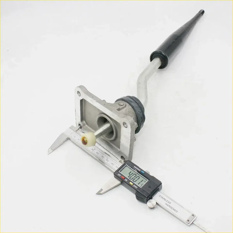 Shift lever retainer for toyota hilux 2004-2015 with a silver metallic gear shift lever, black rubber grip, and aluminum housing