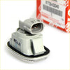 Gray plastic automotive sensor with black rubber gasket and silver trim for side marker light toyota hilux mk6 sr5 back view