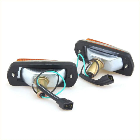 Back side of black plastic side marker light with orange lens and silver interior for Nissan Datsun Fairlady Z models