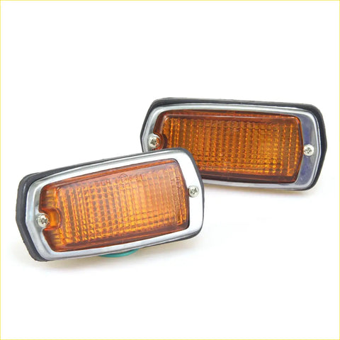 Pair of amber rectangular side marker lights with chrome bezels and black rubber trim for nissan datsun fairlady z