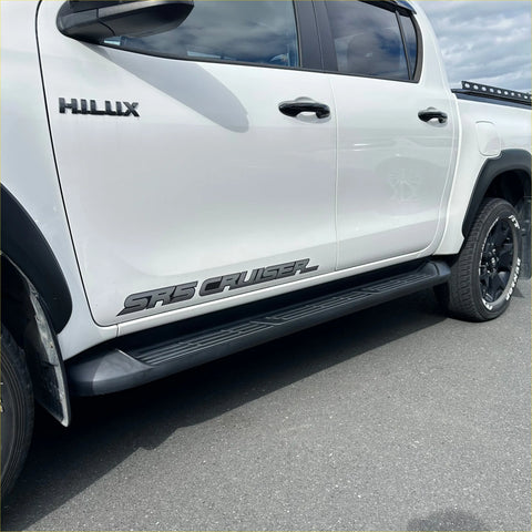White toyota hilux double cab with black srs cruiser side decals and matching side step running boards oem style 2015-2026