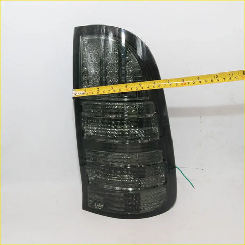 Black smoked led tail light for toyota hilux mk6 sr5 2004-2010 with textured layered design and clear lens sections