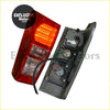Back side of smoked led taillights for isuzu d-max 2012-2020 showing red lens clear cover and wiring harness