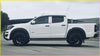 White chevrolet colorado pickup with smooth black flares side steps and black wheels for 2017 to 2021 models