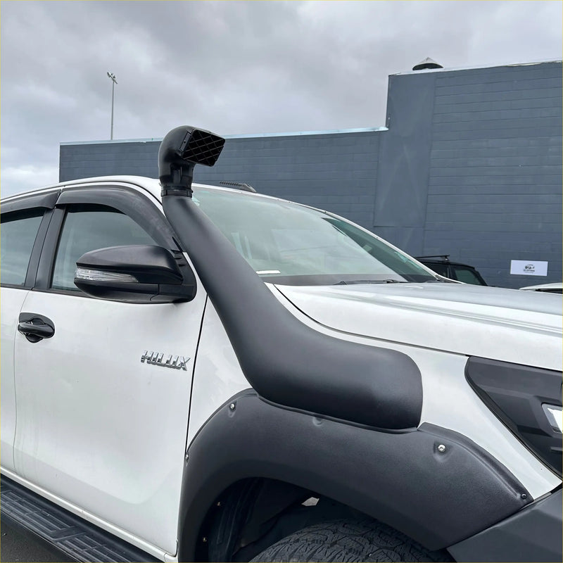 Black rubber snorkel mounted on white isuzu hilux pickup truck shown from the back side for toyota hilux 2015-2025