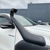 Black rubber snorkel kit mounted on white toyota hilux for 2015-2025 models enhancing off-road air intake