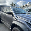 Silver metallic tubular roof rack made of stainless steel mounted on gray toyota hilux pickup truck back side
