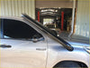 Black stainless steel roof rack with glossy finish mounted on silver toyota hilux revo 2015+ back side view