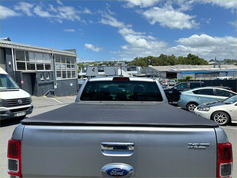 Silver ford ranger pickup truck back with black soft tonneau cover ideal for isuzu d-max double cab use
