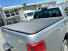 Back side of a gray fabric-covered soft tonneau cover on a silver mazda bt-50 2012-2020 double cab pickup truck