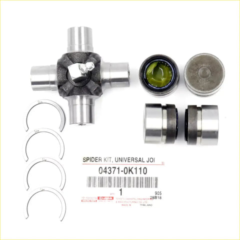 Silver universal joint spider kit with black rubber bushing and green grease-filled bearing for Toyota Hilux 2012-2015