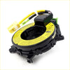 Black plastic spiral cable clock spring with yellow warning label and wiring for mitsubishi pajero montero backside view