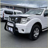 White nissan frontier pickup with black bumper guard and silver alloy wheels featuring stainless steel nudge bar