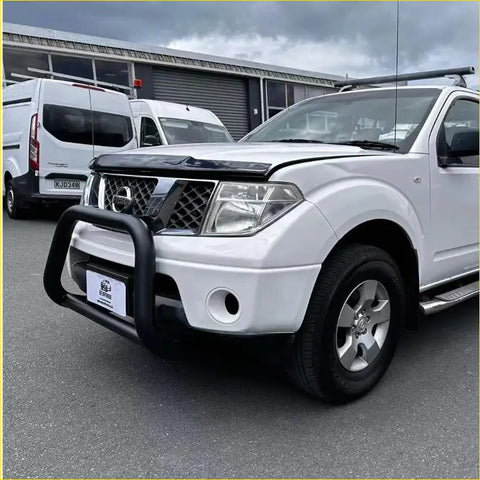 White nissan frontier pickup with black bumper guard and silver alloy wheels featuring stainless steel nudge bar