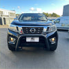 Black nissan navara pickup with matte black stainless steel nudge bar and chrome grille with black bumper guard