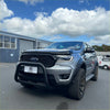 Silver ford ranger pickup with stainless steel nudge bar and black front bumper guard for off-road use