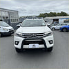 White toyota hilux pickup truck with matte black stainless steel nudge bar and black front bumper guard