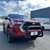 Red toyota hilux with matte black stainless steel nudge bar and black front bumper guard from 2021 to 2025 model