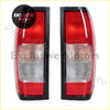 Back side of black framed red and clear textured lens tail light assembly for nissan navara d22 1997-2015