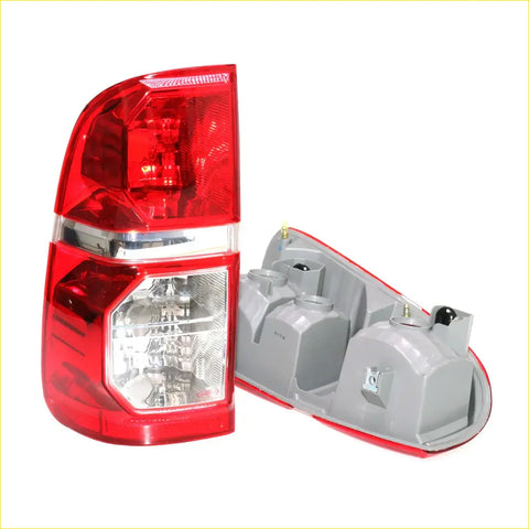 Rear view of red and clear plastic tail lights with chrome trim for toyota hilux sr5 2004-2015 x2